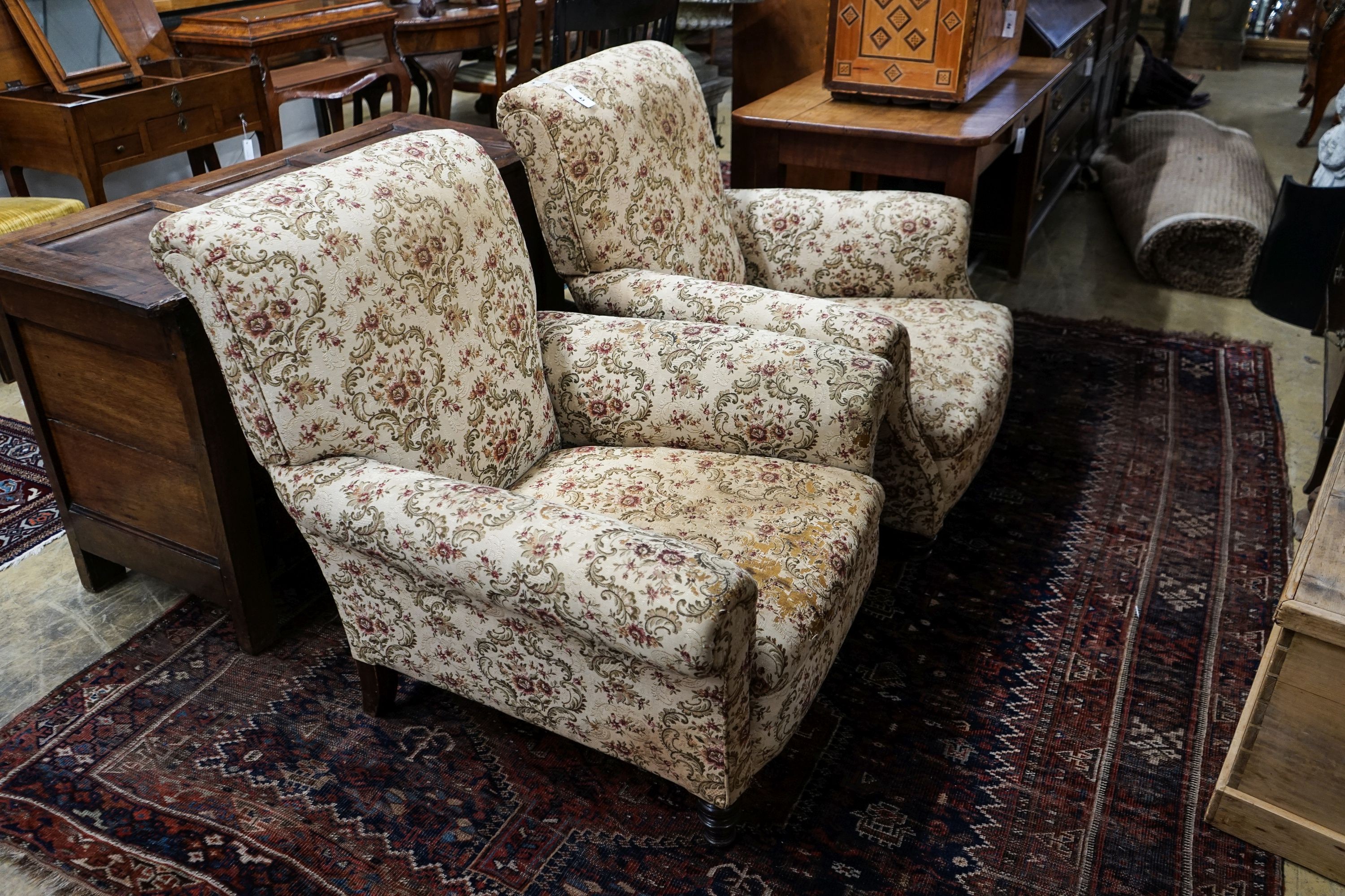 A near pair of late Victorian upholstered armchairs, width 88cm, depth 86cm, height 96cm